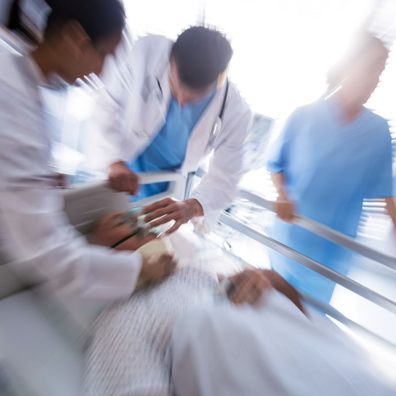 medical professionals surrounding a patient needing oxygen